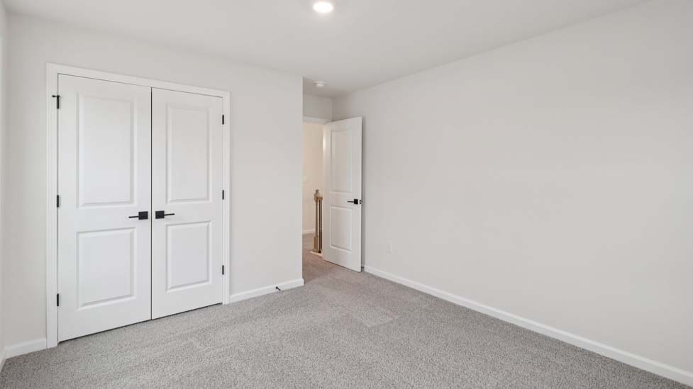 Carpeted bedroom with windows