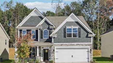 Fleetwood front exterior with brick and siding and two car garage