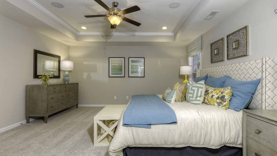 Primary suite carpeted with two windows