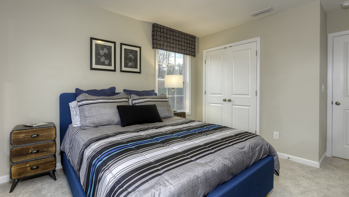 Carpeted bedroom with 3 windows