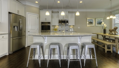 Kitchen and island with white cabinets