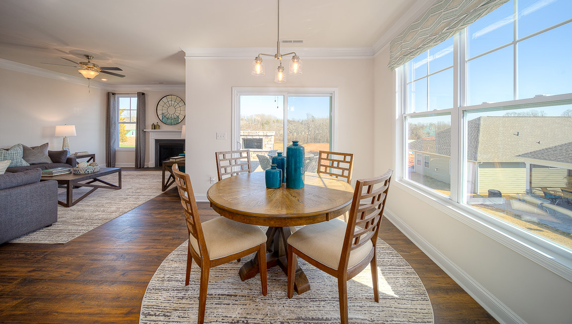 Eating area beside kitchen, wood floors, and sliding glass back door