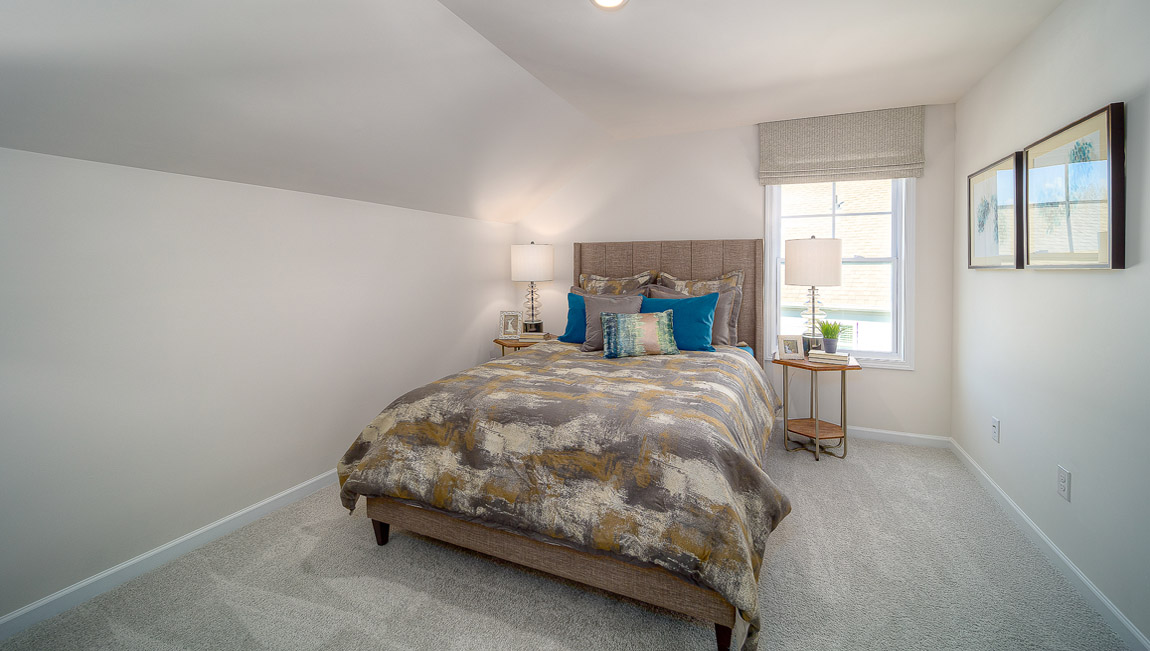 Carpeted bedroom with small window