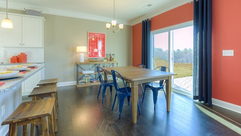 Casual dining area beside kitchen and sliding glass back door