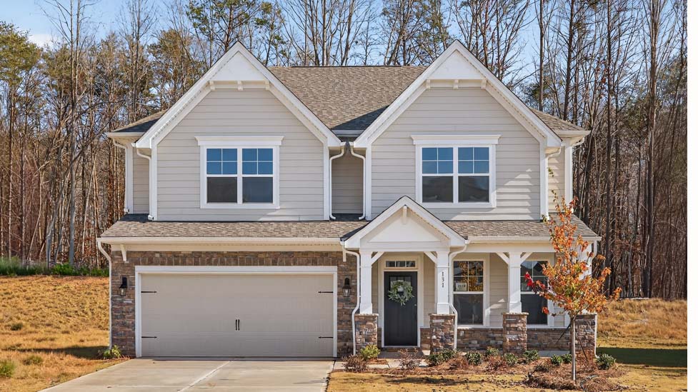 London front exterior with siding and stone and two car garage