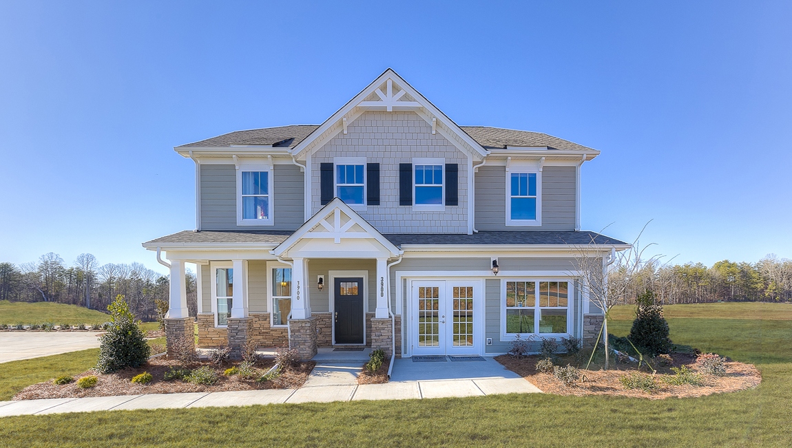 London front exterior with siding and stone and two car garage