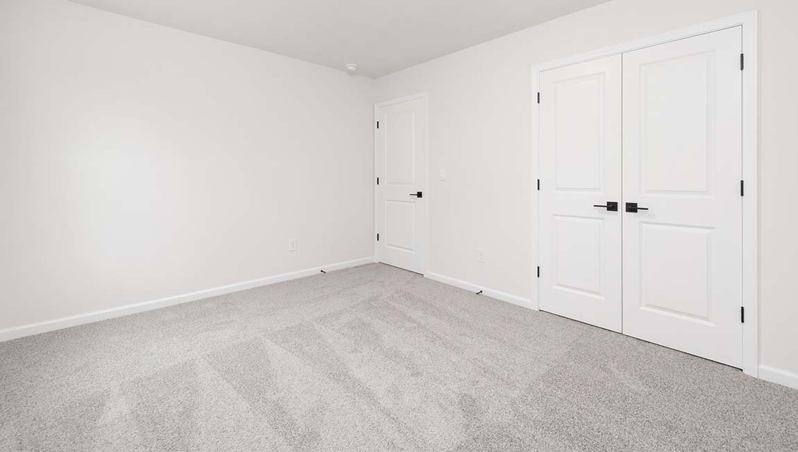 Carpeted bedroom with small window
