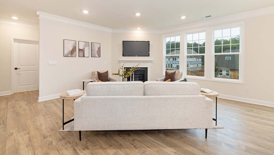 open concept living room with fireplace and view of kitchen, breakfast area and staircase