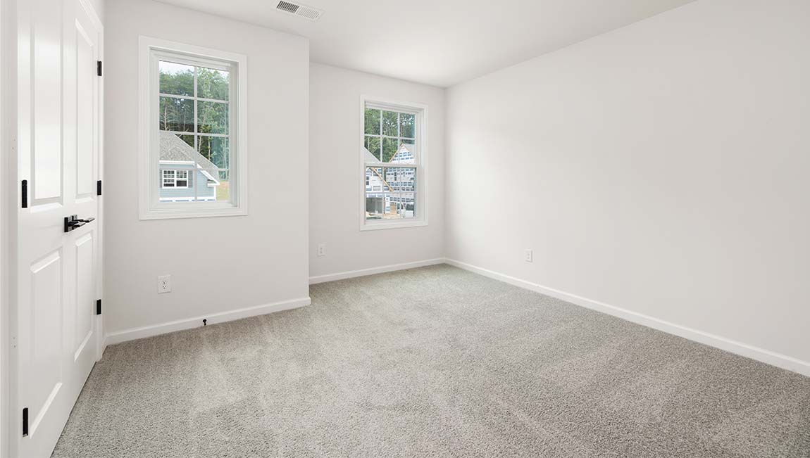 Carpeted bedroom with small window