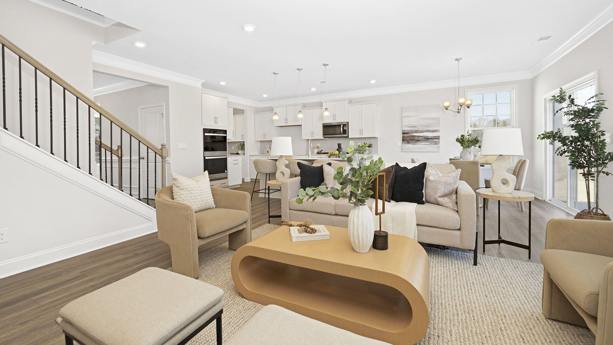 open concept living room with fireplace and view of kitchen, breakfast area and staircase