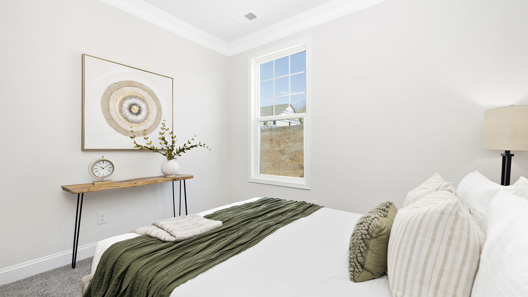 Carpeted bedroom with small window