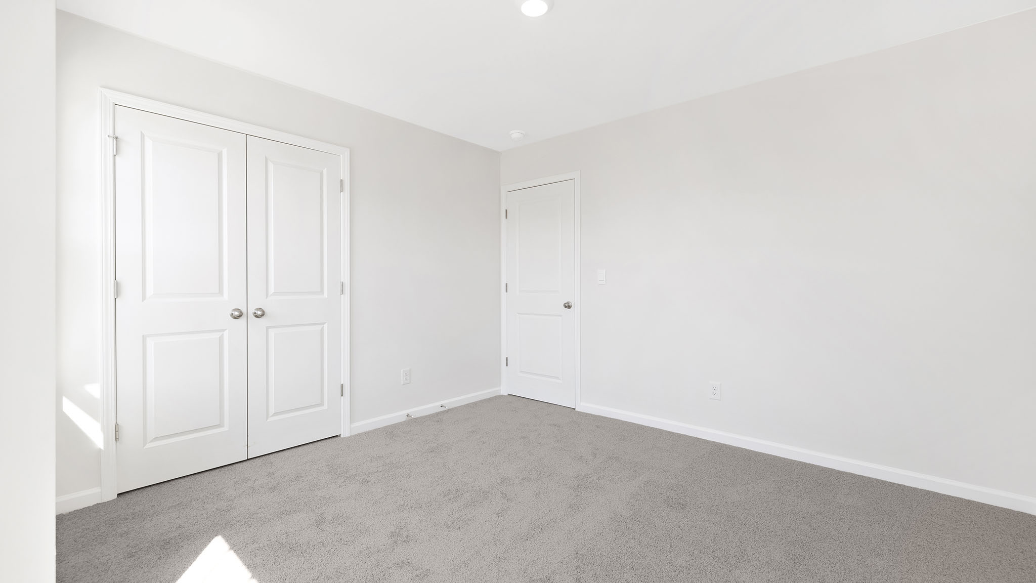 Carpeted bedroom with small window