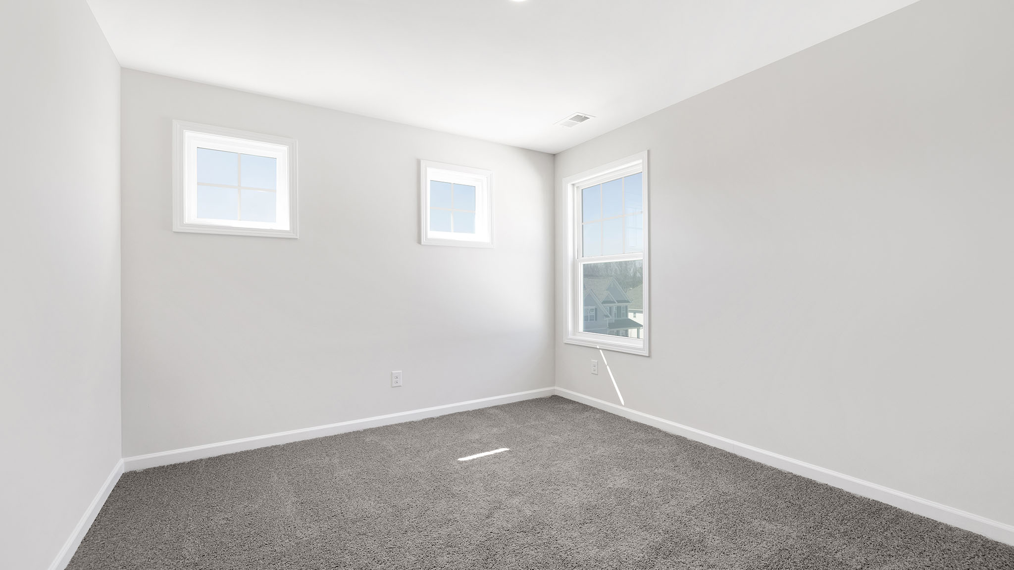 Carpeted bedroom with small window