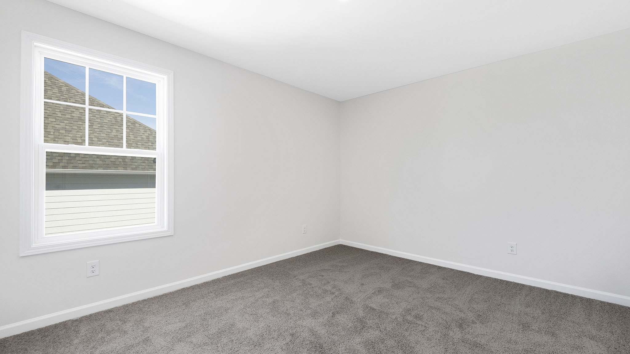 Carpeted bedroom with small window