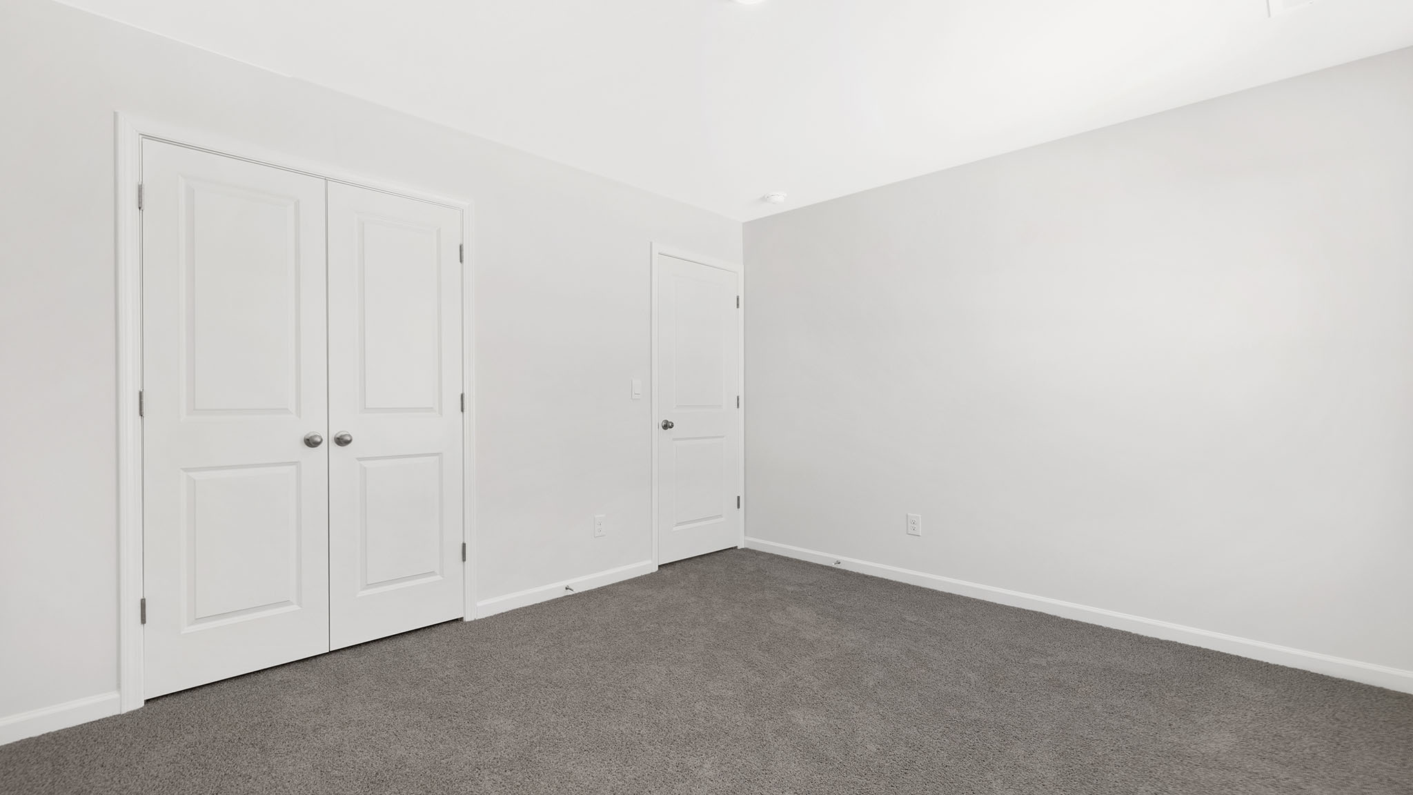 Carpeted bedroom with small window