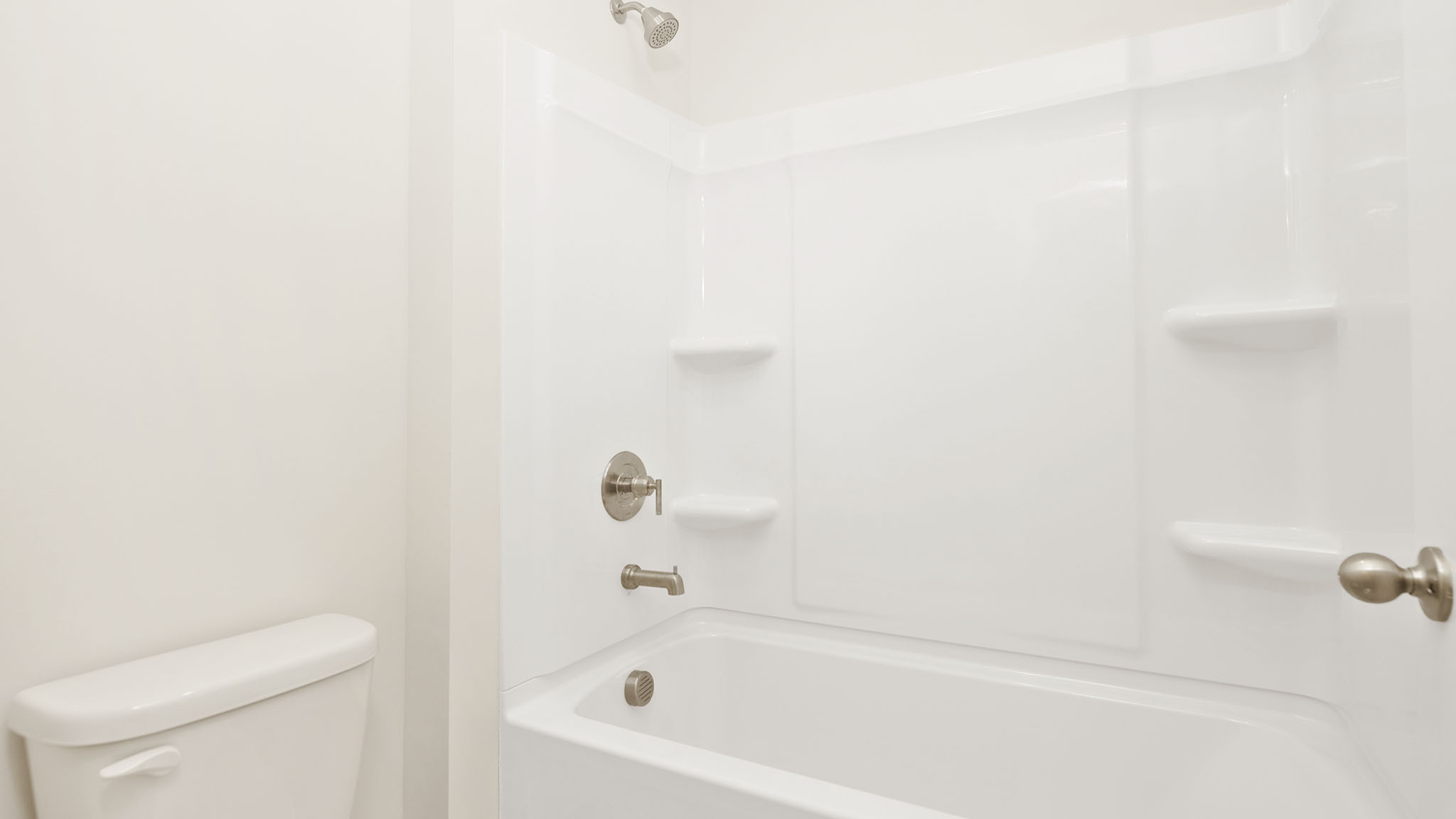 Bathroom with double sink vanity and bathtub shower combination