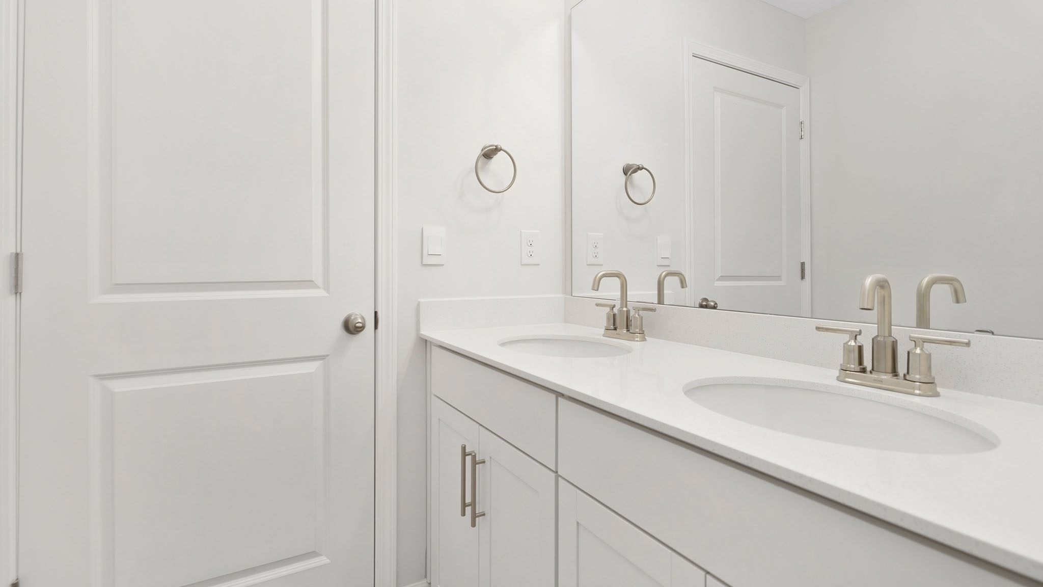Bathroom with double sink vanity and bathtub shower combination