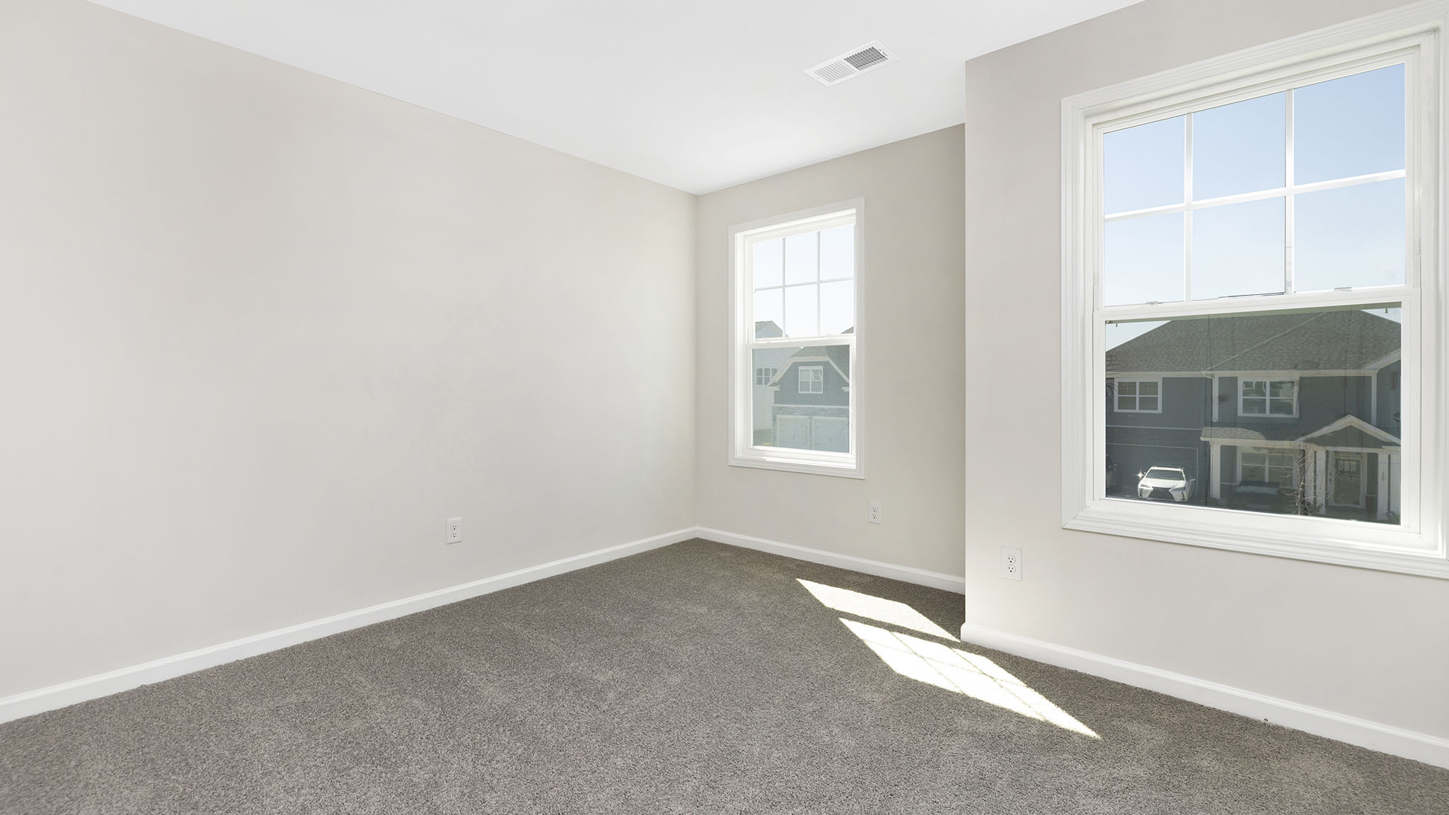 Carpeted bedroom with small window