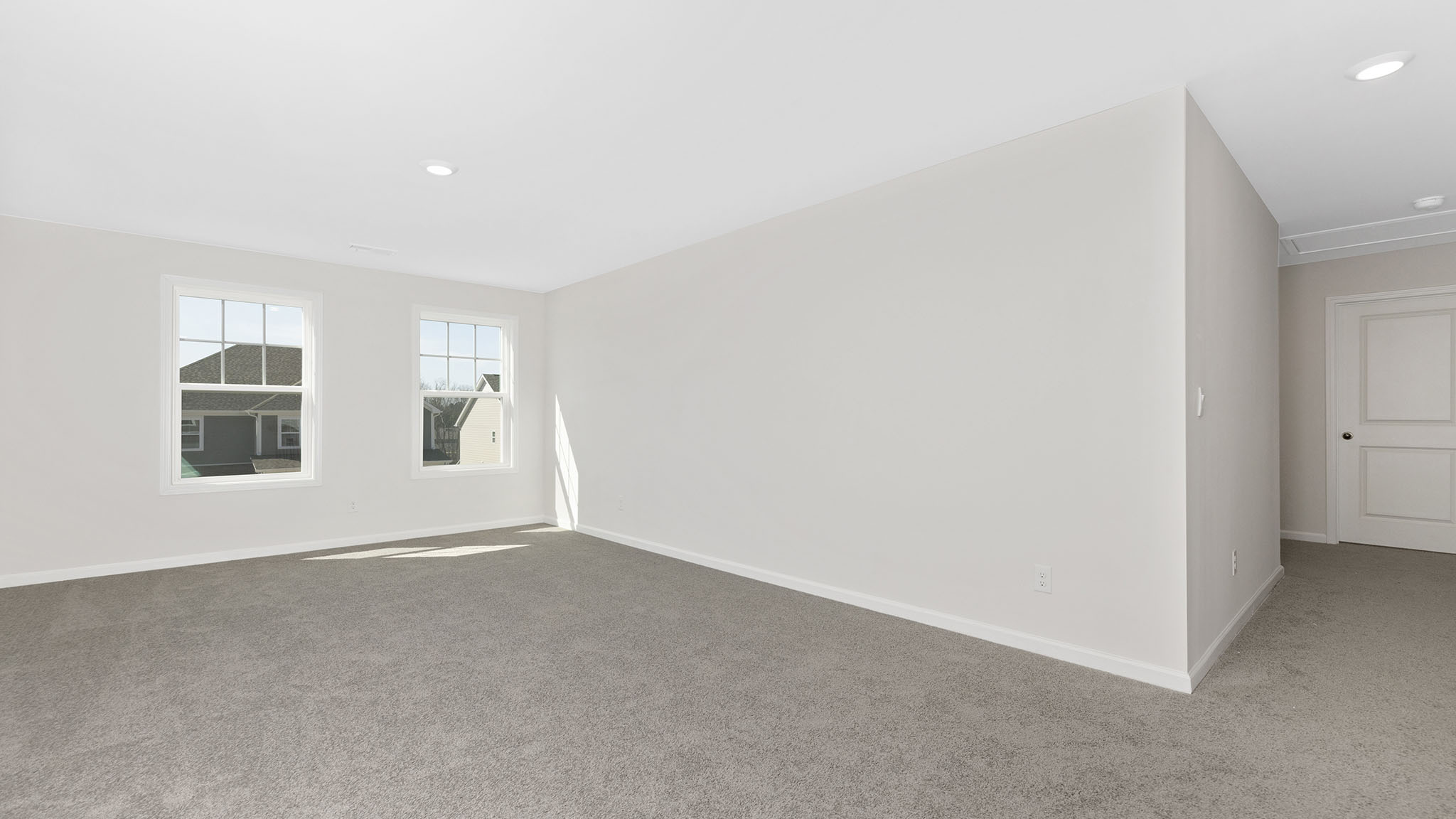 Carpeted bedroom with small window