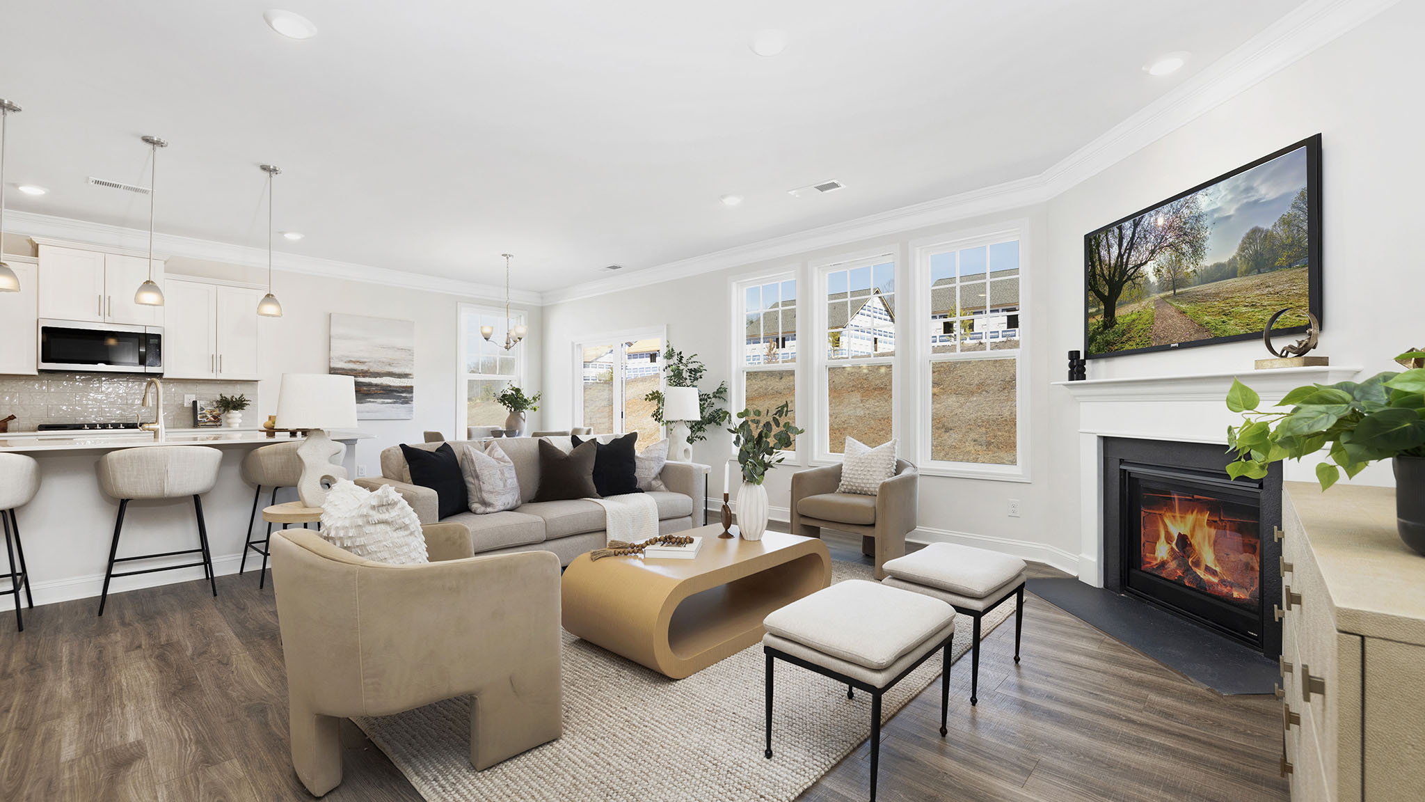 open concept living room with fireplace and view of kitchen, breakfast area and staircase