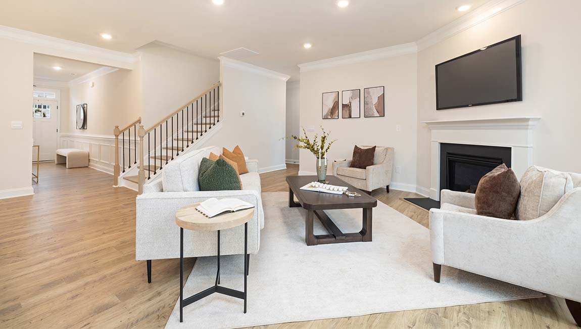 open concept living room with fireplace and view of kitchen, breakfast area and staircase