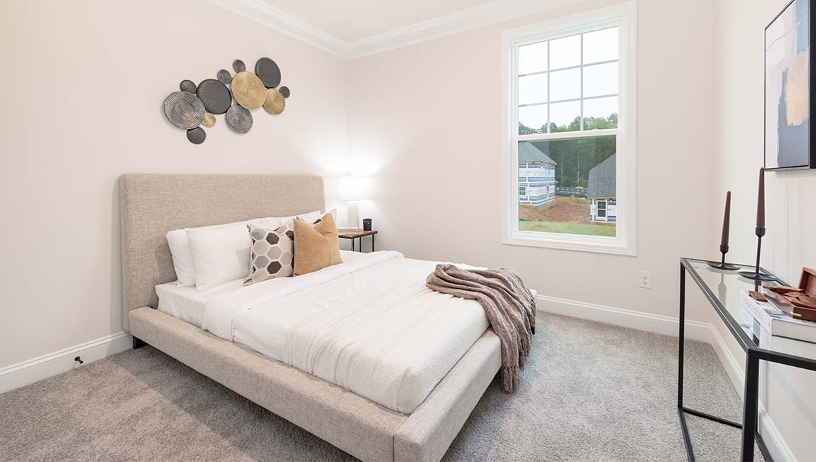 Carpeted bedroom with small window