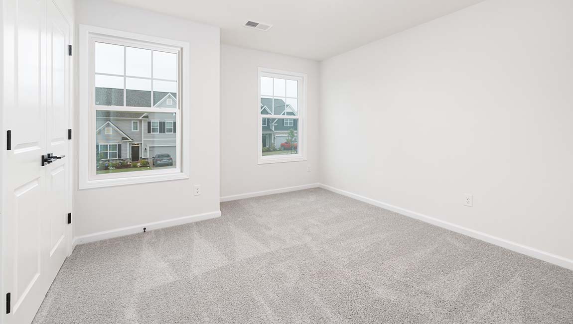 Carpeted bedroom with small window