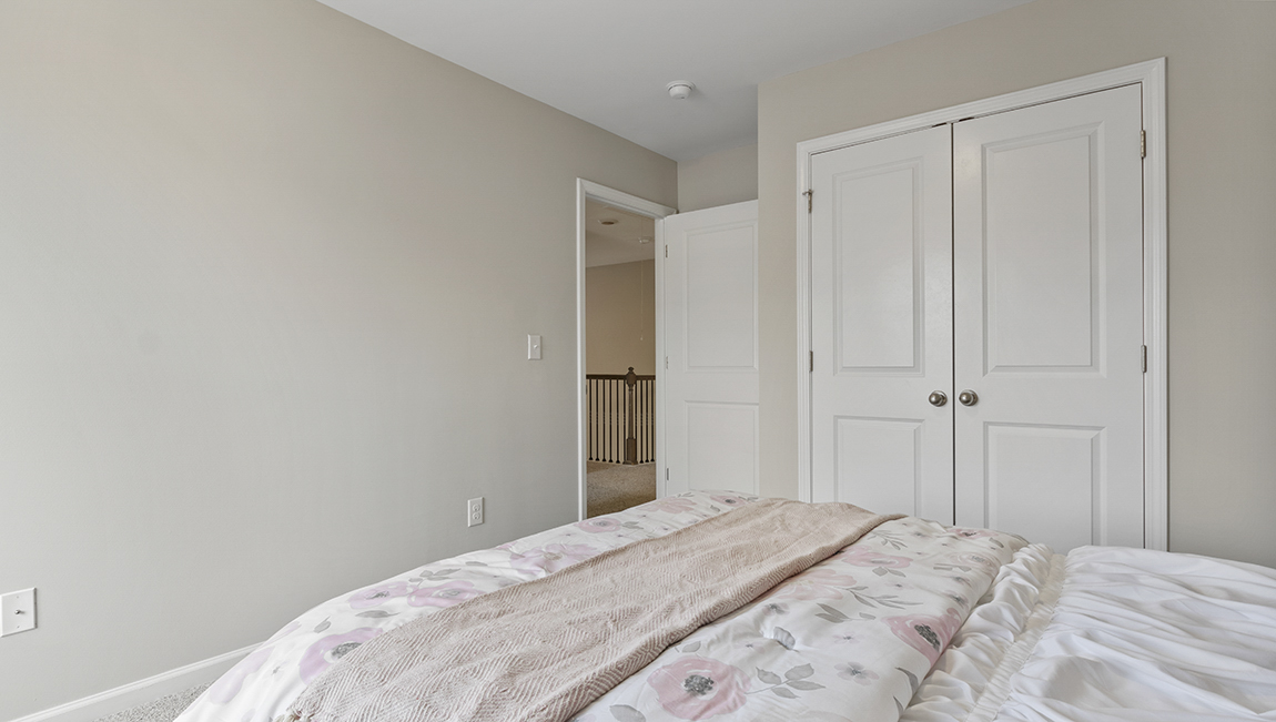 Carpeted bedroom with large window