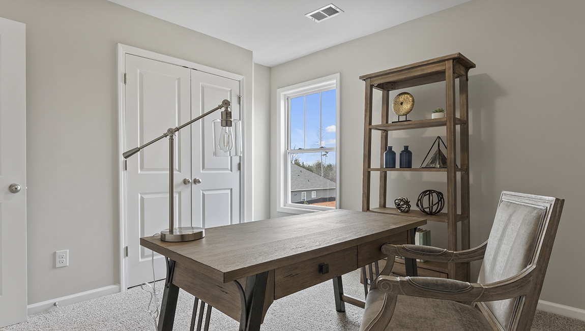 Carpeted bedroom with large window