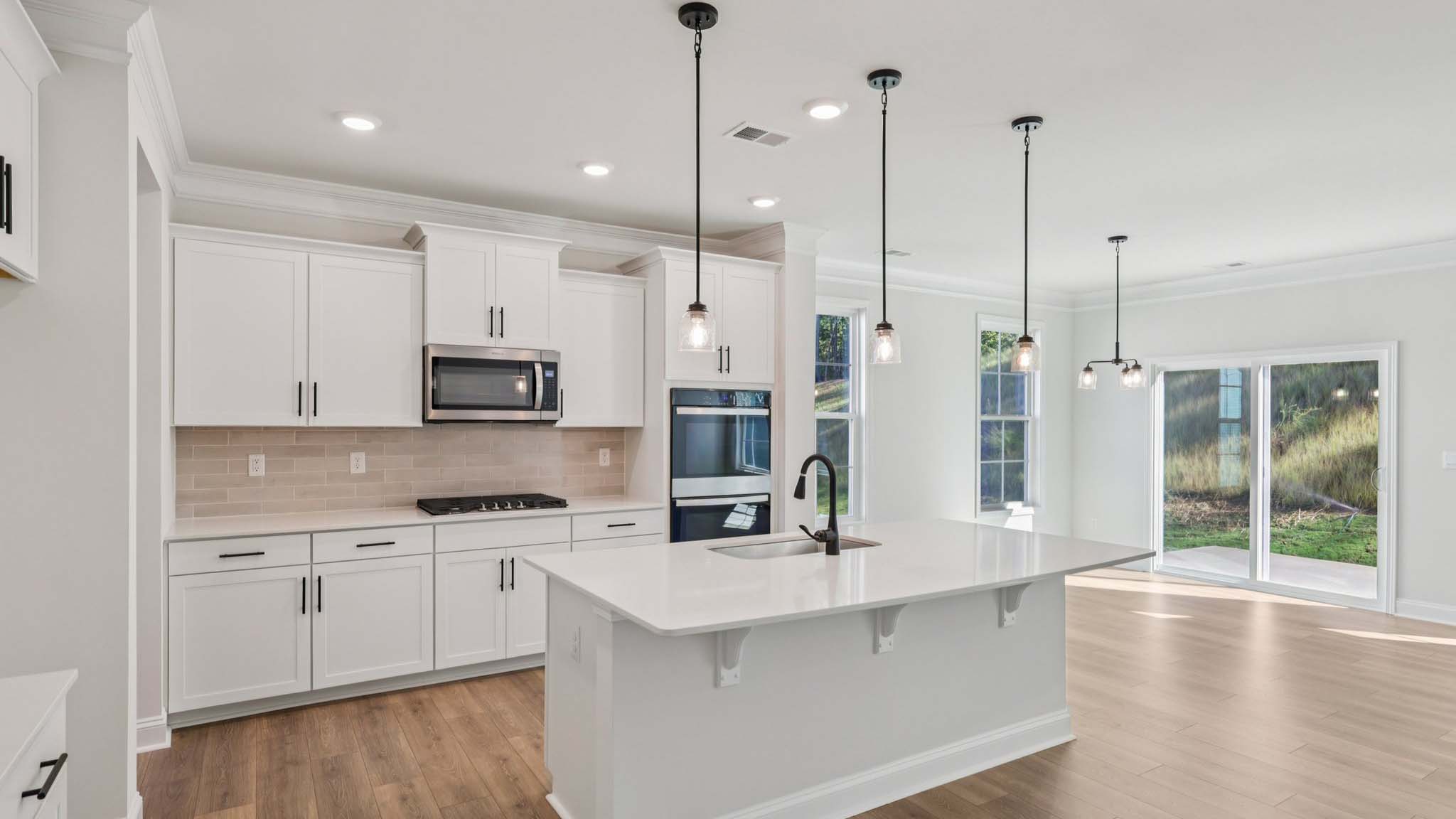 Kitchen and Island with white cabinets and stainless steel appliances