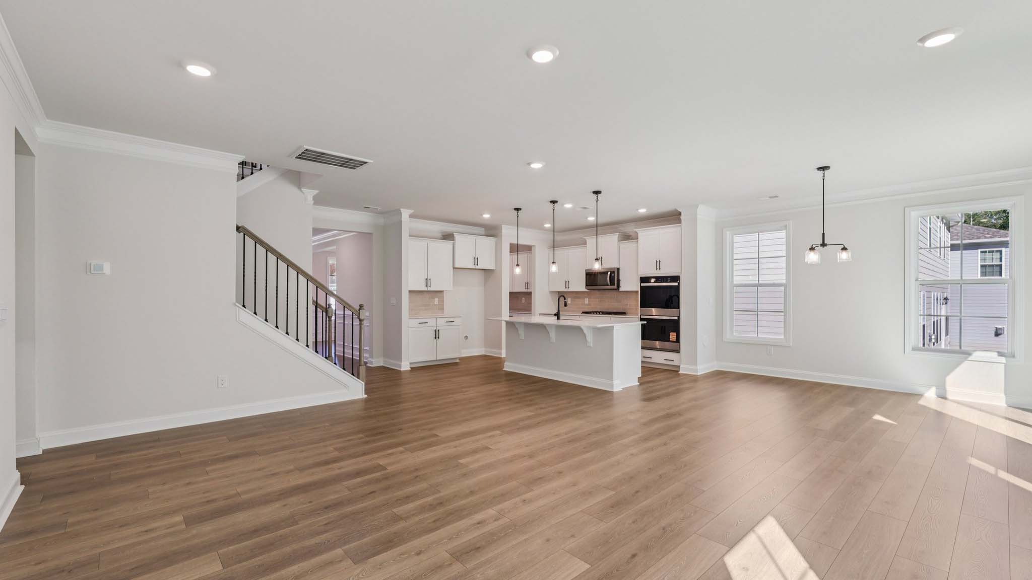 Open concept living room with windows and fireplace