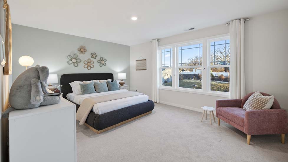 Carpeted bedroom with windows
