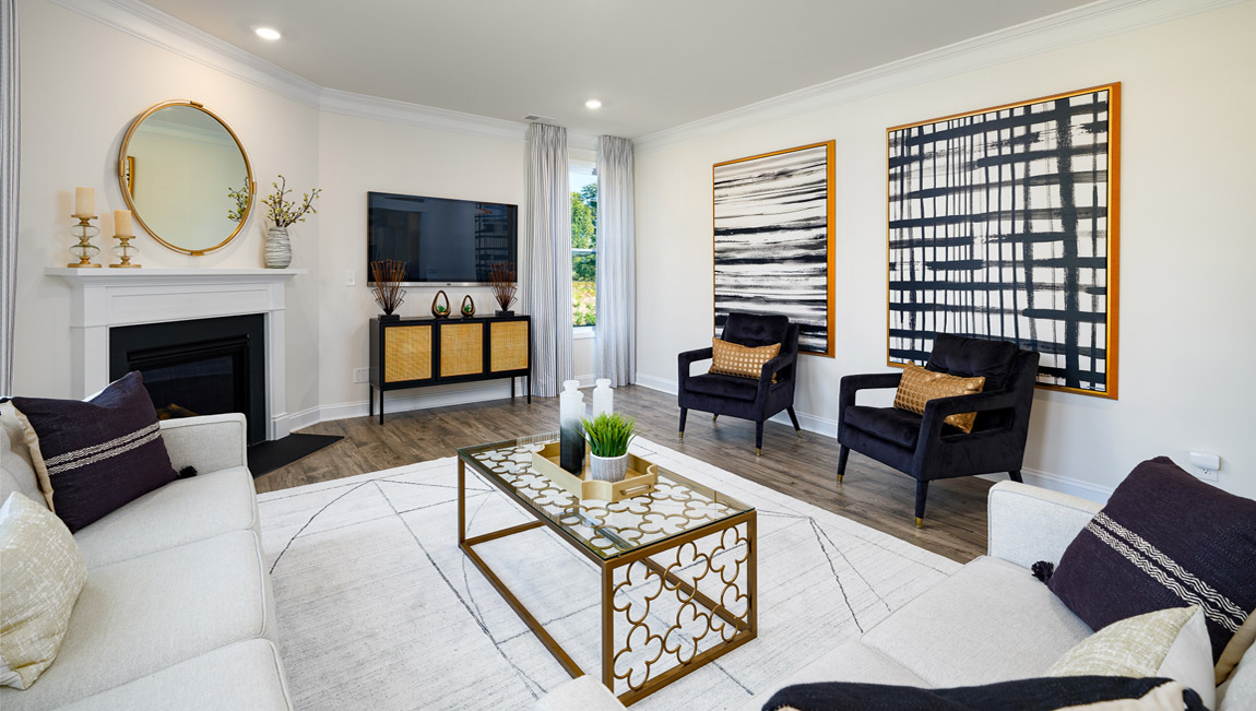 Open concept family room with wood floors, 3 large windows, and fireplace
