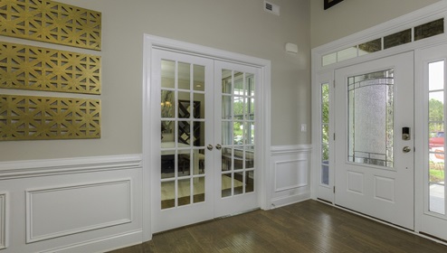 Welcoming foyer with view of front door and french doors to flex room