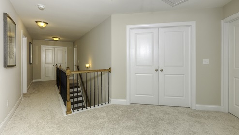 Upstairs landing space with carpet