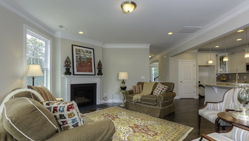 Family room with wood floors, fireplace and many large windows