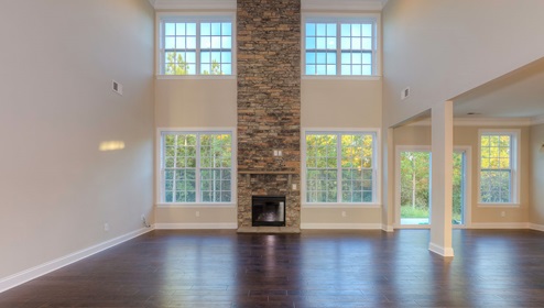 Modern open-concept family room with brick chimney wall and fireplace