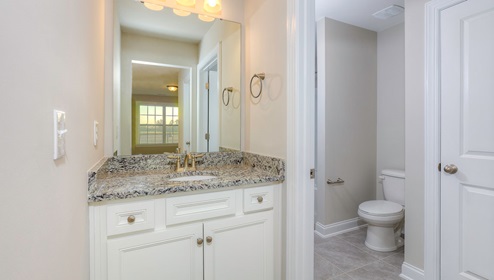 Bathroom with bathtub, and white cabinets
