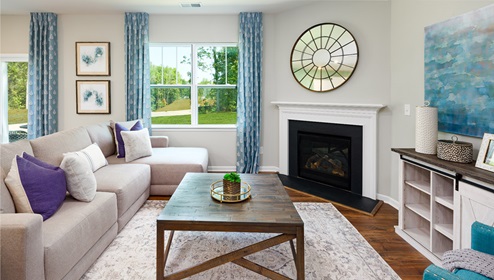 Azalea Ridge model open family room with windows and fireplace