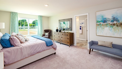 Azalea Ridge Model primary carpeted bedroom with large window