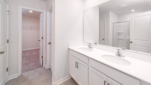Primary bathroom with white counters and cabinets