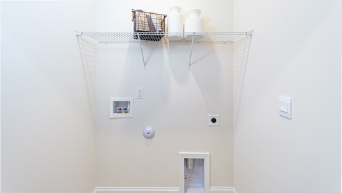 Laundry Room with built in racks above machine space