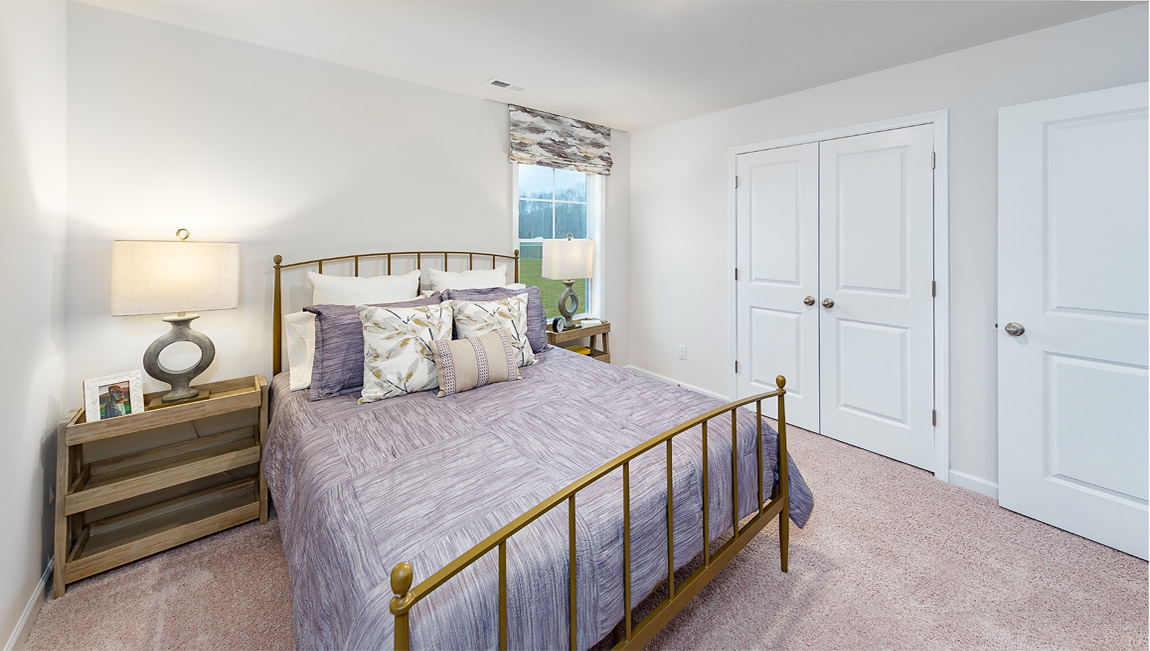 Carpeted bedroom with large window