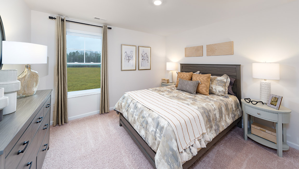 Carpeted bedroom with large window