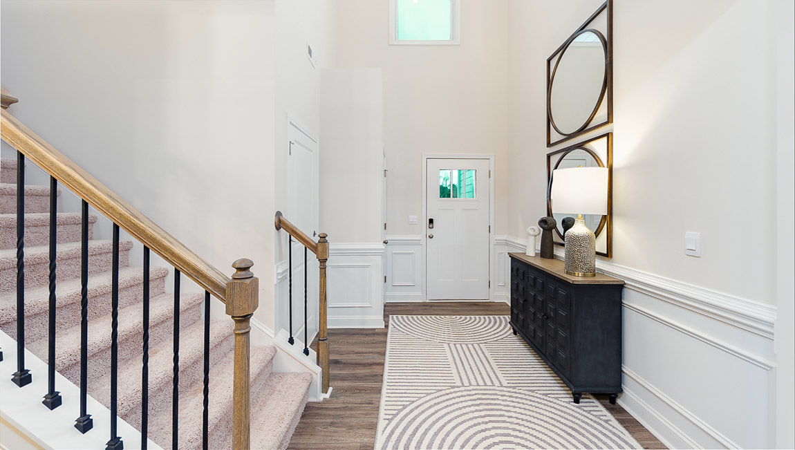 Welcoming foyer view of front door, and staircase
