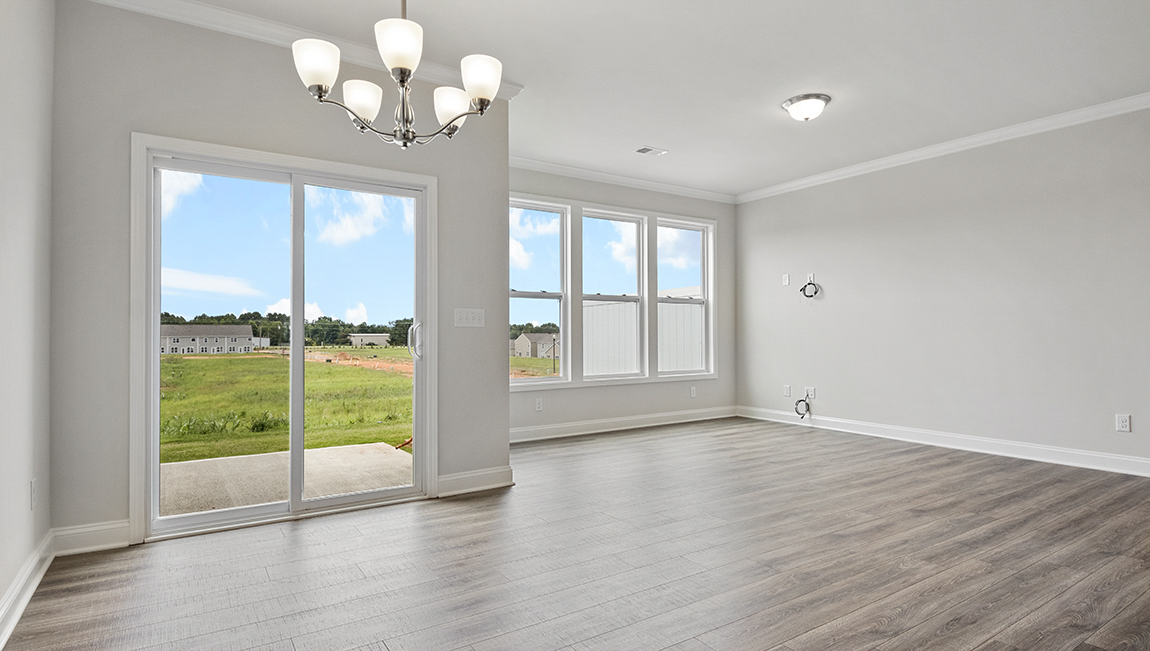 Dining area beside kitchen with sliding glass back doors