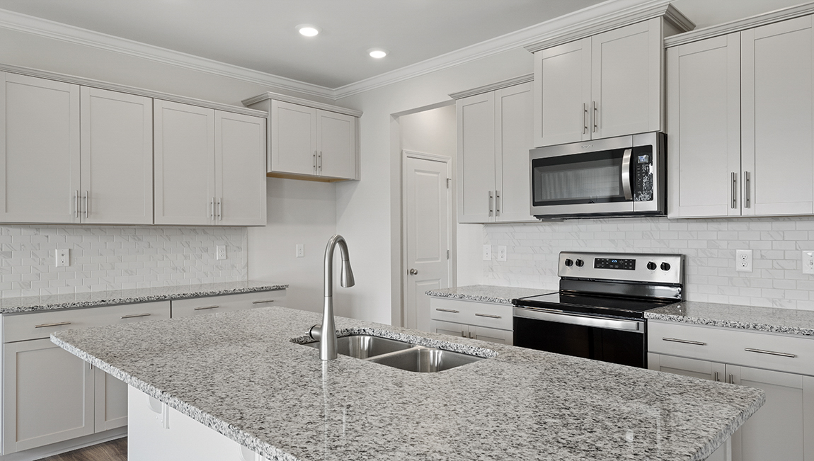 Kitchen and island with stainless steel appliances