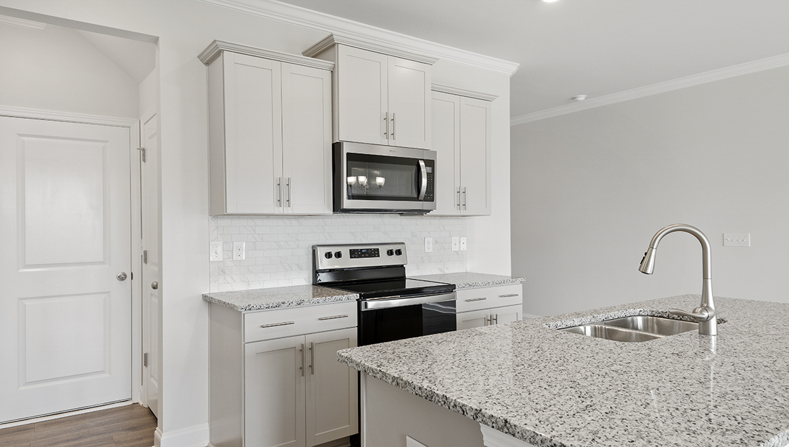 Kitchen and island with stainless steel appliances