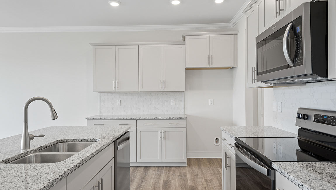 Kitchen and island with stainless steel appliances