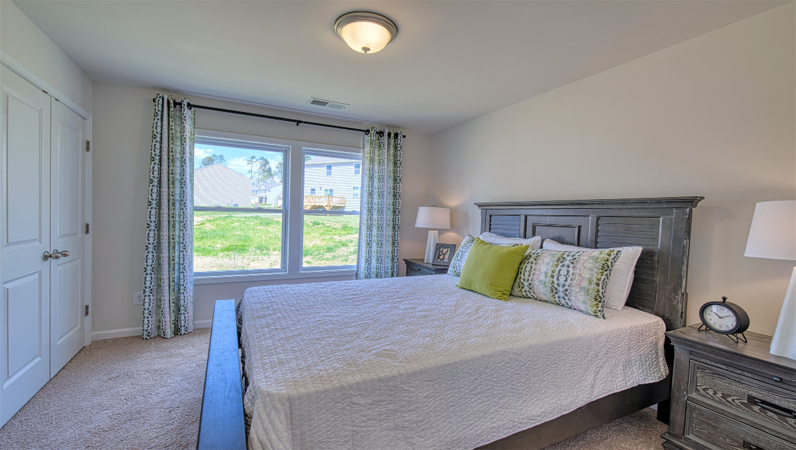 Carpeted bedroom with large window